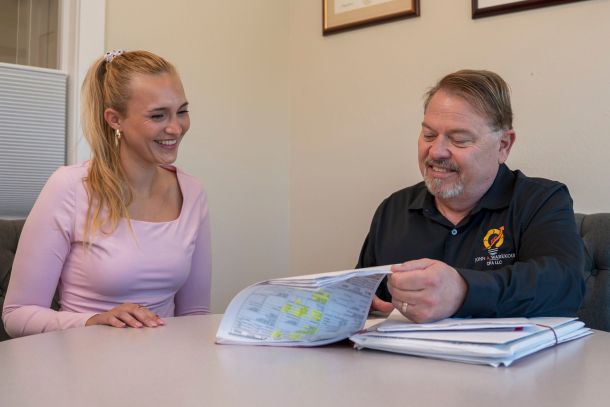 John Warekois and a client looking over paperwork